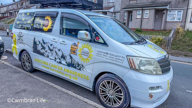 a camper van covered in stickers to raise awareness of sarcoma cancer