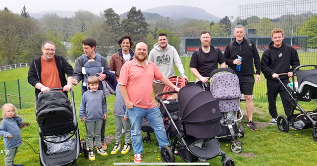 a group of dads. many with prams