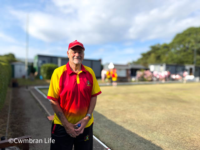 Dave mason in a red baseball cap by a bowling green
