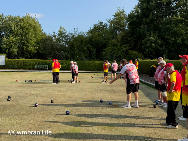 a group of men bowling on a green