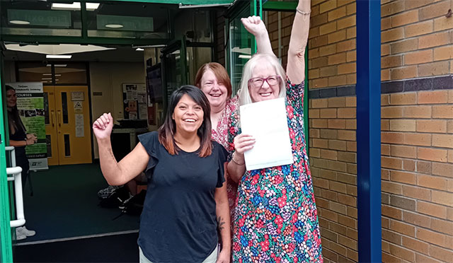 Three adult GCSE learners celebrate their results in Torfaen
