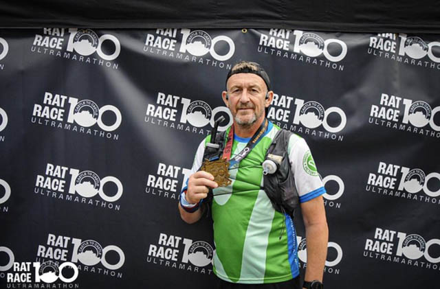 Paul Mason holds his medal after completing the Rat Race Castle to Castle race from Bamburgh to Edinburgh