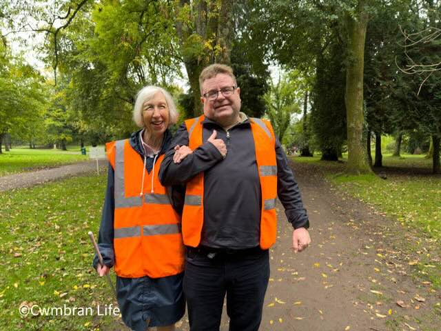 a man and women both wearing orange high viz tops