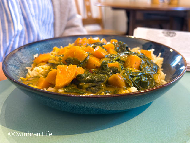 a plate of satay curry and rice