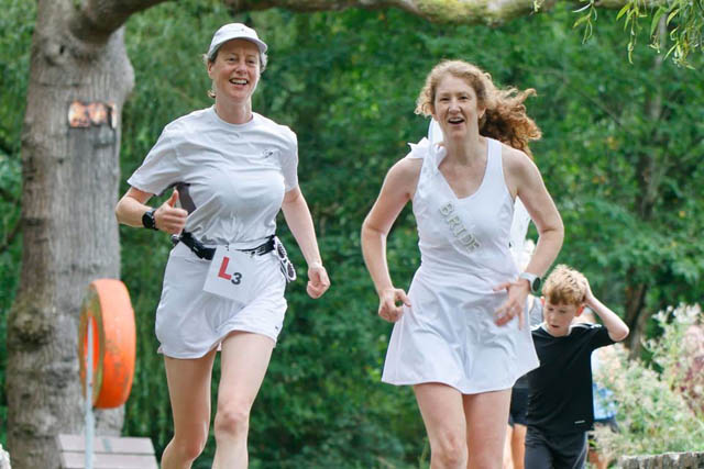 two women in white running