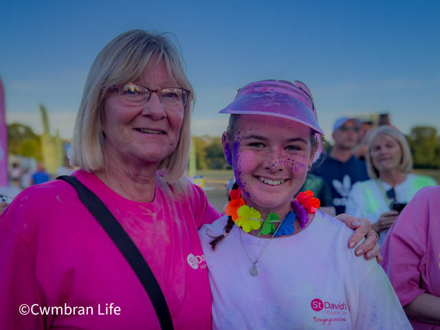 a woman with her arm around a teenage girl who has just fun 5km