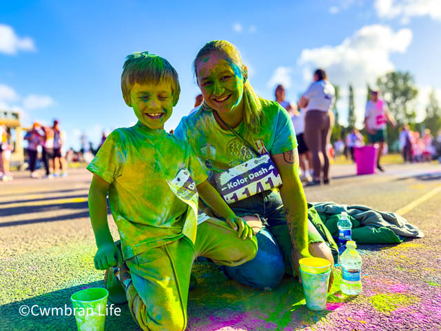 a mum and her young son, both covered in powder paint