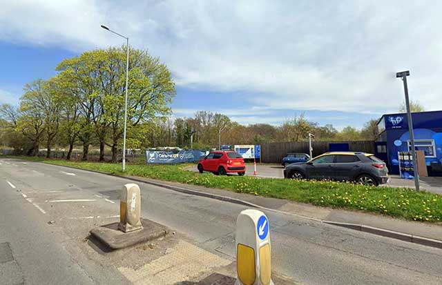 a road with a car wash next to it