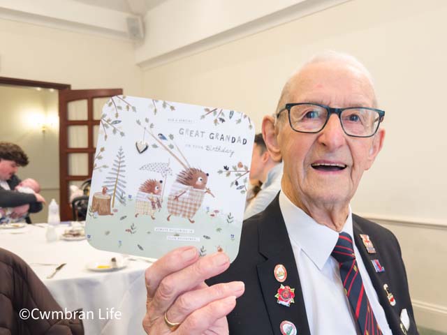 a man holding up a birthday card