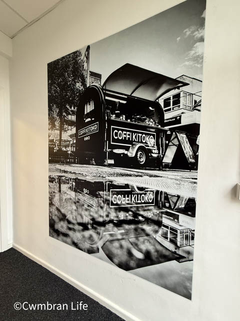 a black and white photo of a coffee pod trailer