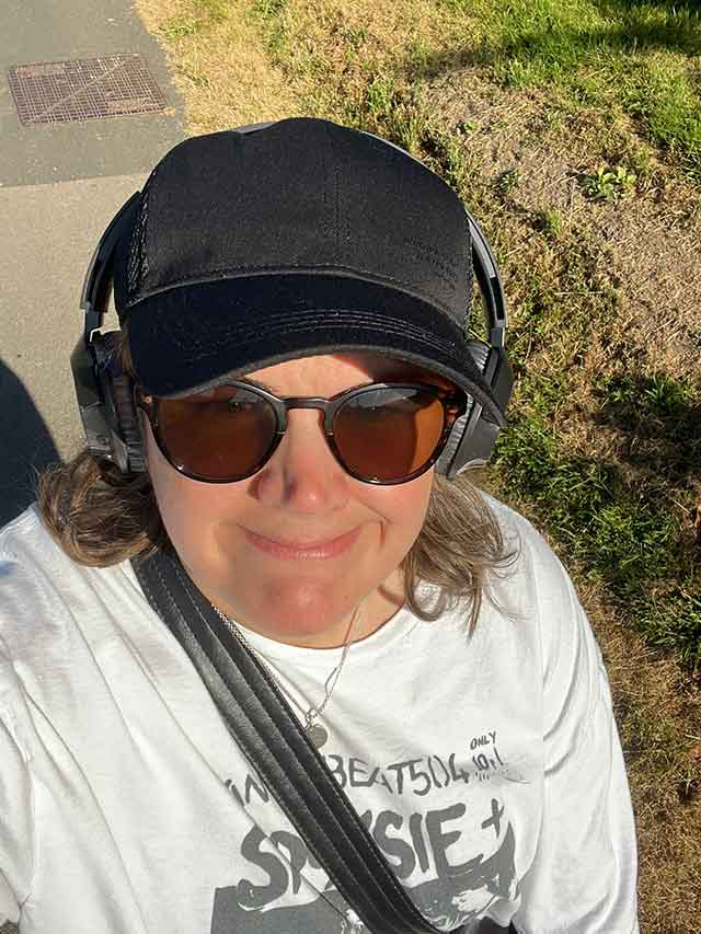 a woman wearing a cap and headphone