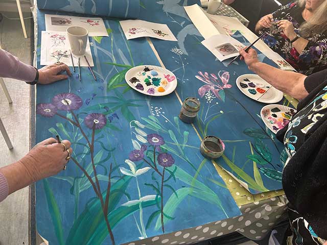people painting art on a table