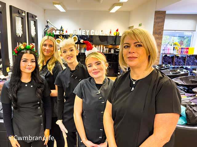 five staff members smiling at the camera in a hairdressers salon