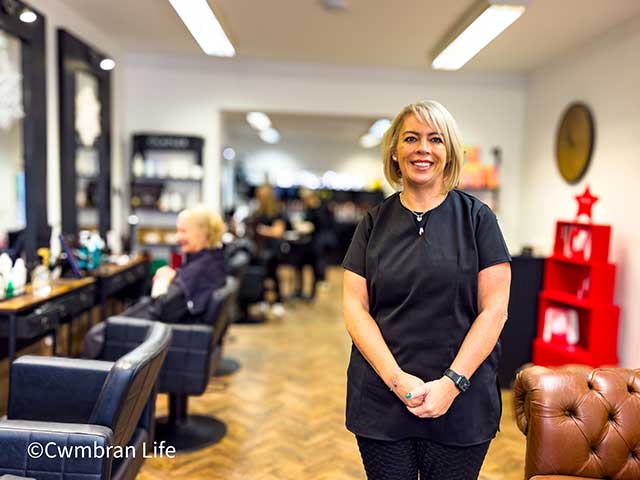 a hairdresser stood in her salon
