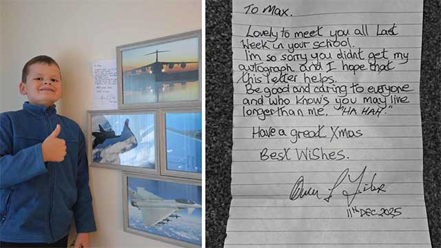 a boy stood by some framed images on a wall- and a handwritten letter