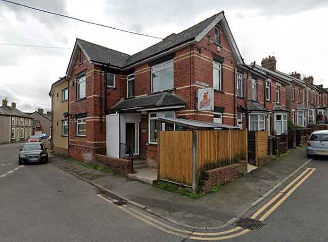 the outside of a large building on the corner of two streets