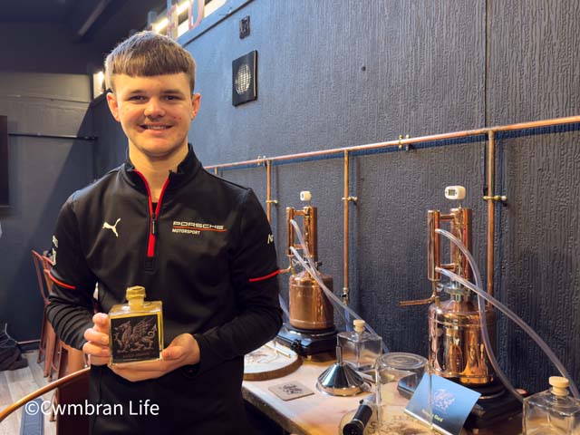 an 18 year old man holding a bottle of spirits 