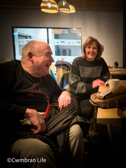 a man in a a wheelchair at a table laughing