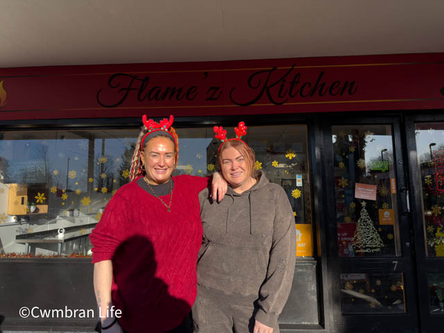 two women outside a cafe called Flamz Kitchen