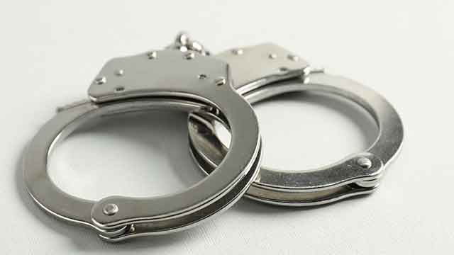 Handcuffs on white background, closeup.