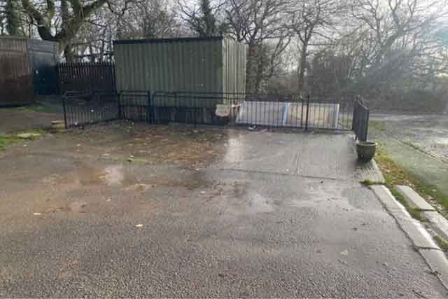 a concrete area and tin shed