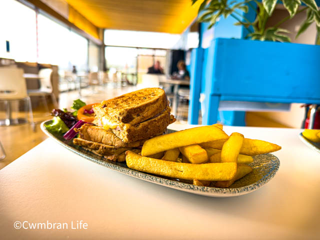 a ham and cheese toastie with chips