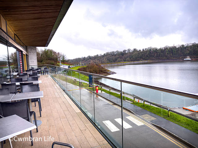 a balcony overlooking a large lake