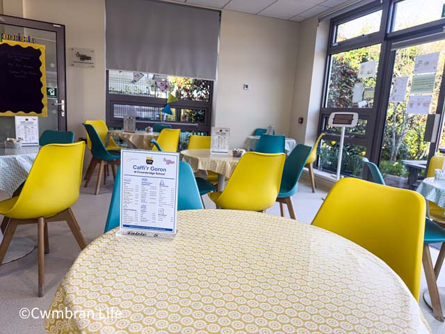 a cafe with tables and chairs and a menu on one table