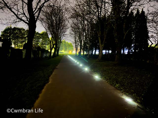 a row of solar panel lights in a footpath