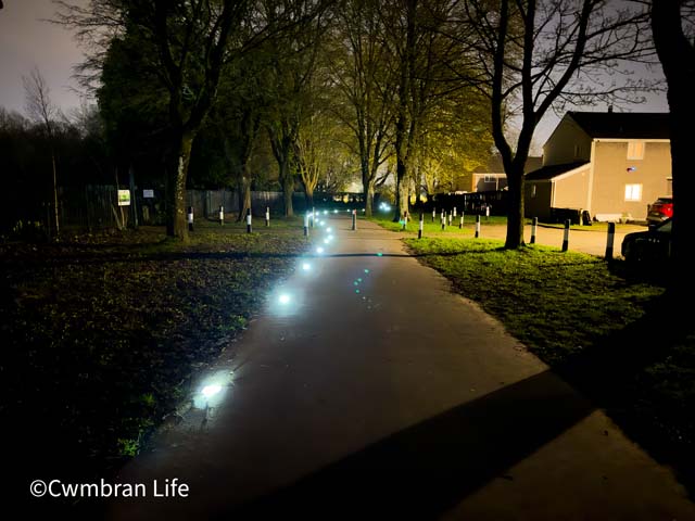a row of solar panel lights in a footpath