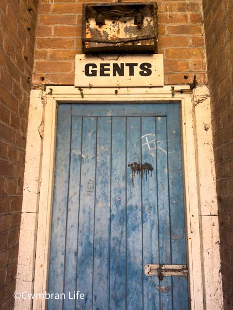 a blue door to a former gents toilets