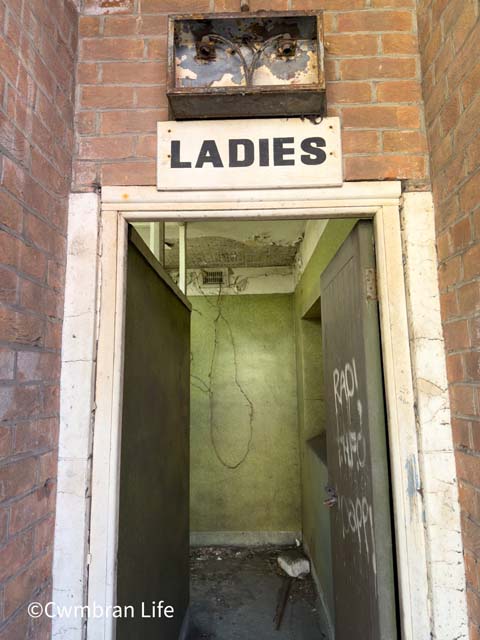 a green door to a former ladies toilets