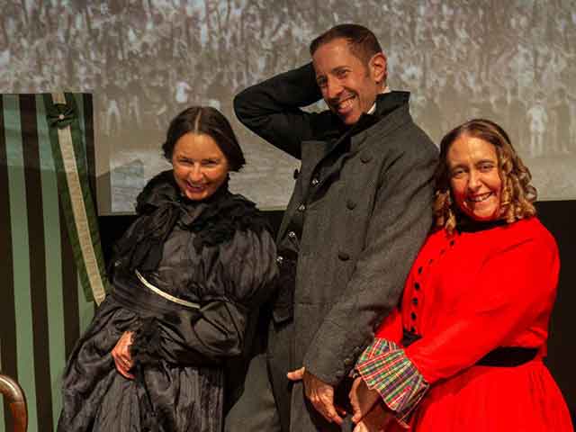 two men and a women in 18th century clothing