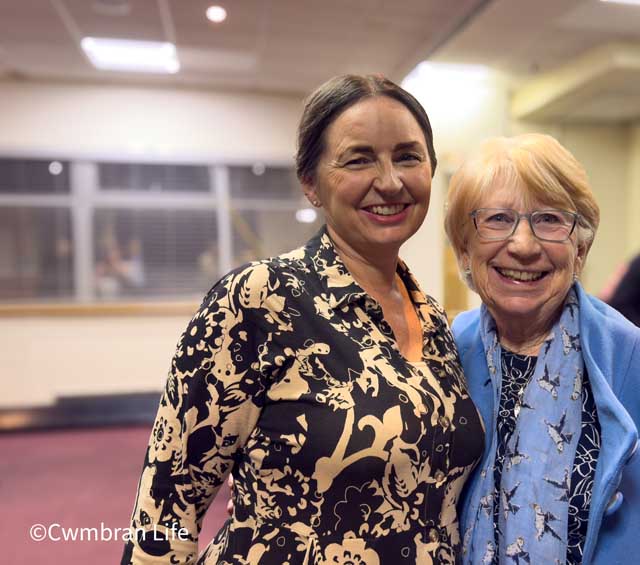 two women smile for the camera
