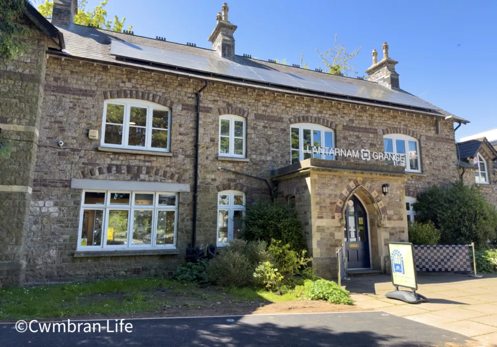 a large brick building with the text Llantarnam Grange on it