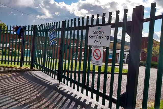 A sign on the gates at New Inn Primary states: 'Strictly Staff Parking Only'.