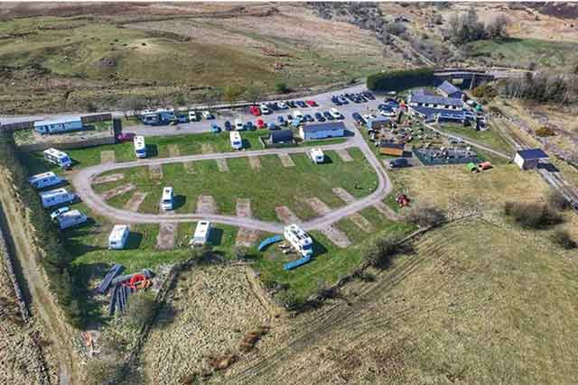 a drone photo overlooking a pub and caravan site