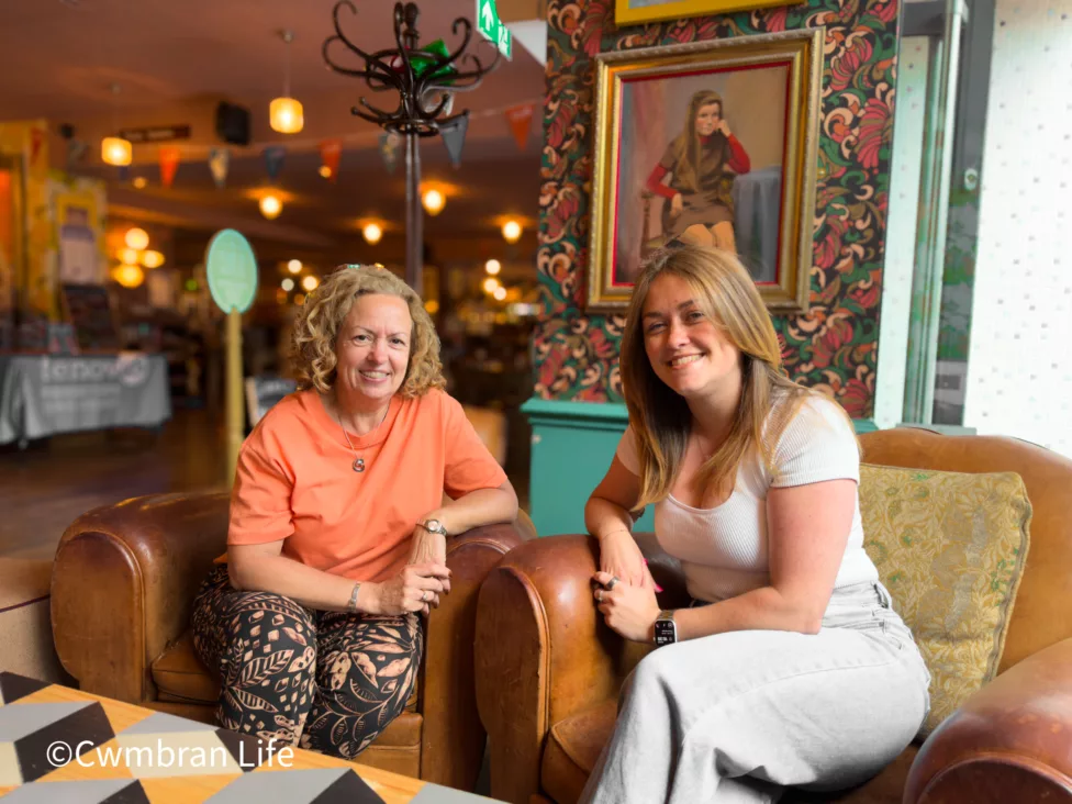 two women on chairs in a cafe bar