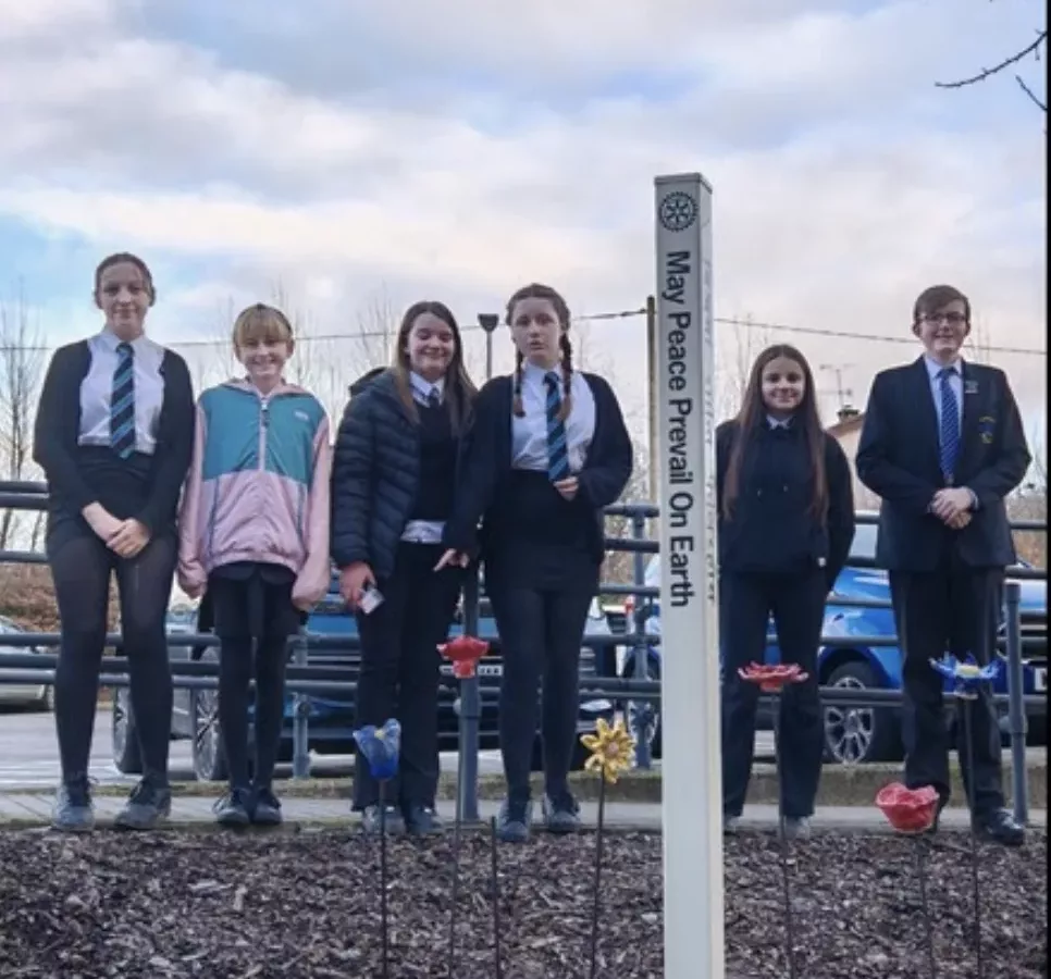 School pupils stood in a garden