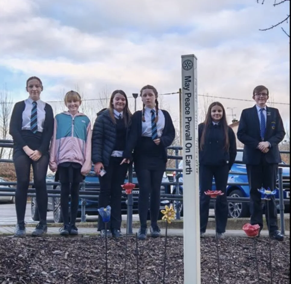 School pupils stood in a garden