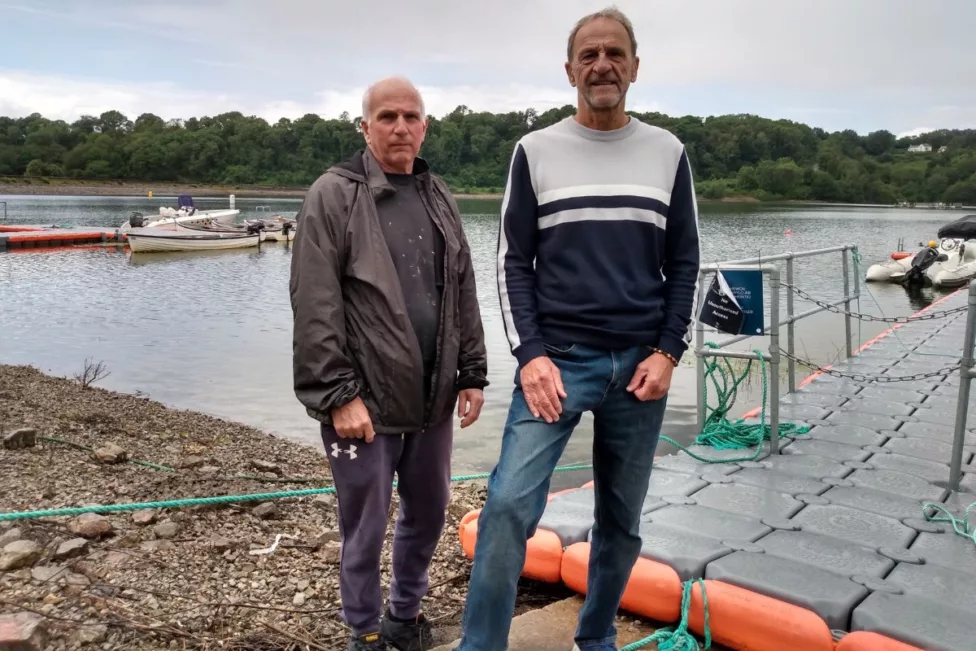 two men by a reservoir