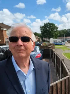 a man stood by a metal railing