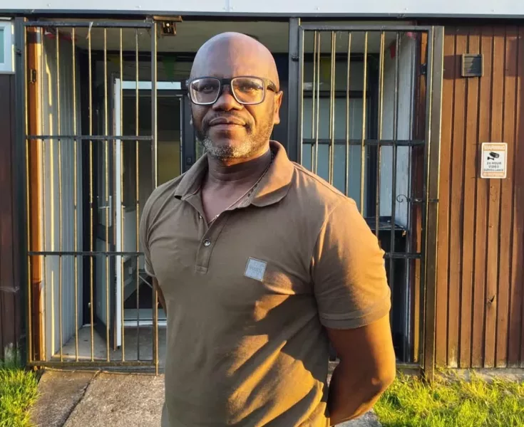 a man stood by the entrance to a community hall