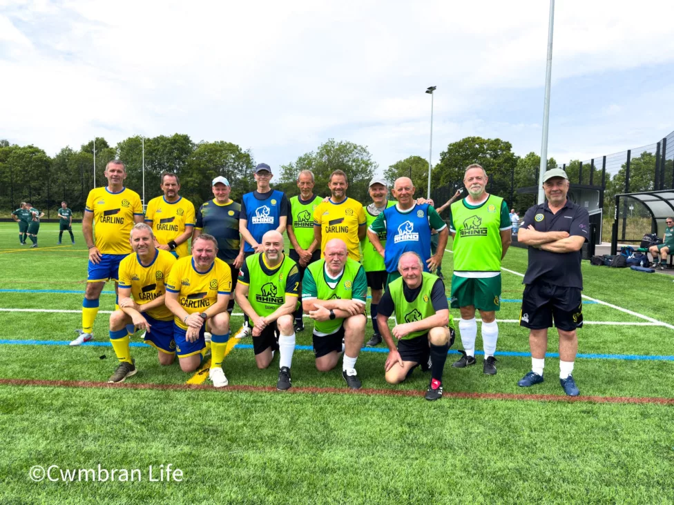 a men's football team have a team photo on a 3G pitch