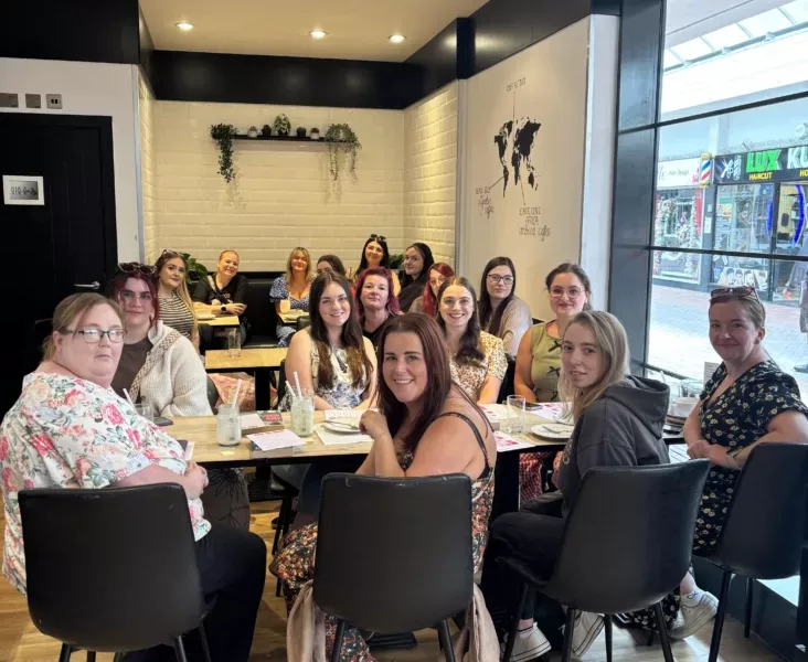 a group of people in a coffee shop sat at tables