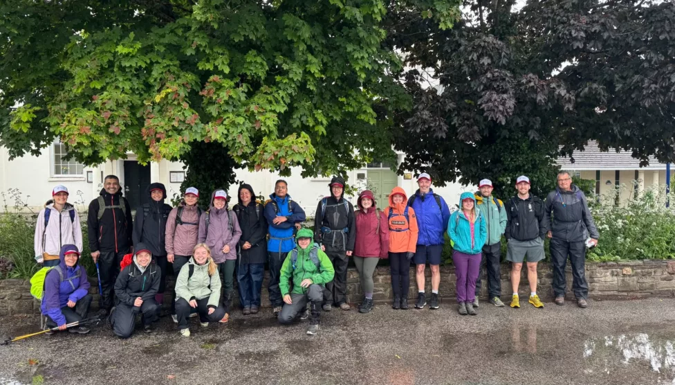a group of men and women next to a tree