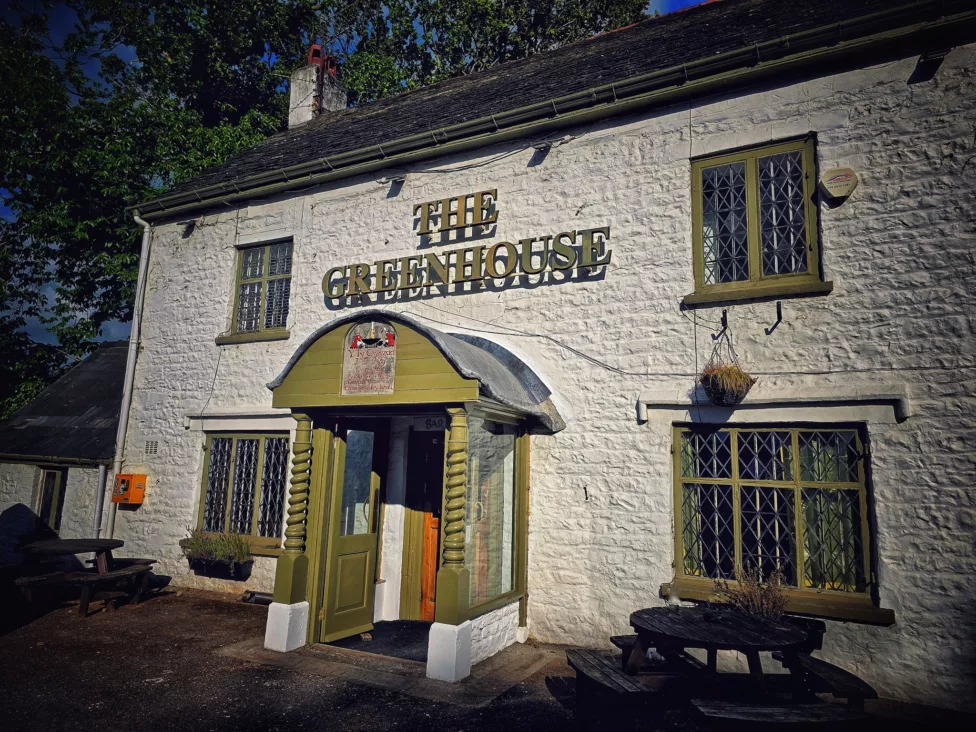 the entrance to a pub called the greenhouse