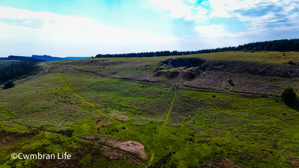a hillside with a quarry dug into it
