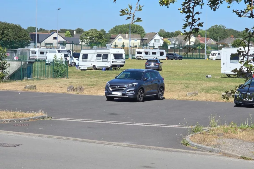 caravans and cars on a football field