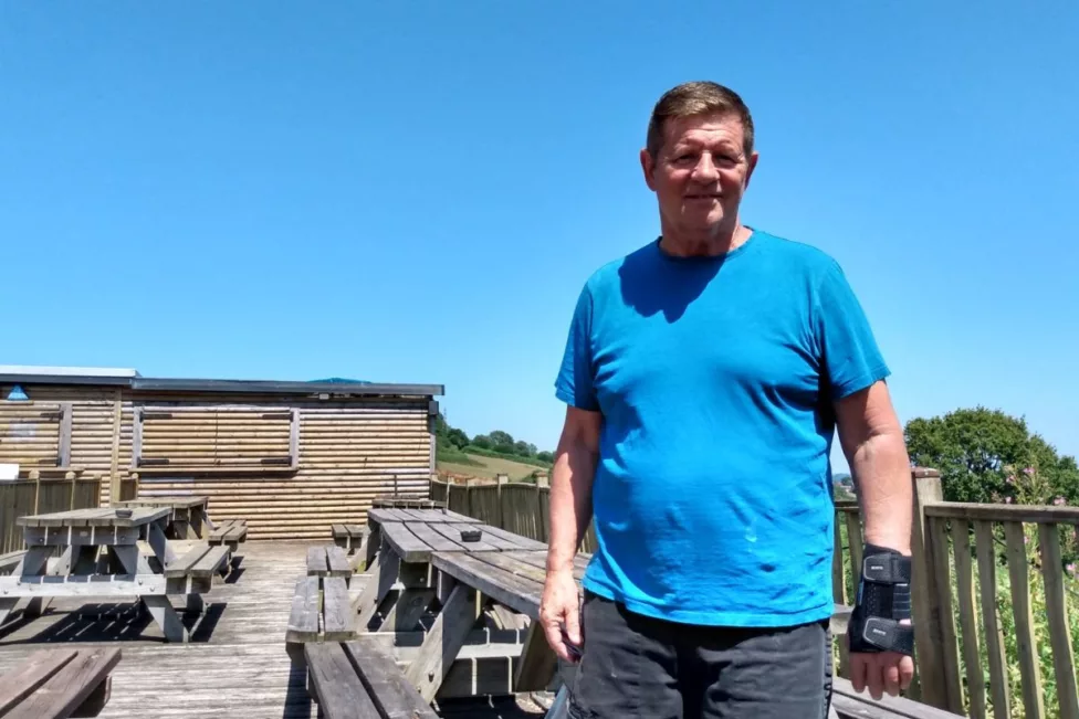 a man stood by some decking